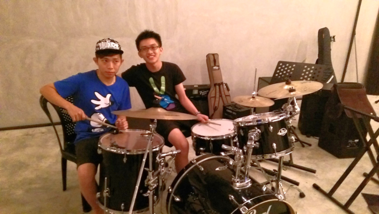 Wei Ze (right), a bassist on our worship team, started out learning the drums in our School of Worship. Here, he is offering tips to the Malaysian drummer, Wei Jie, who is debuting on their worship team.